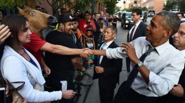President Obama Shaking Hands with a Man in a Horse Head Mask