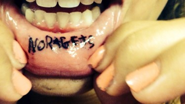 Inner Lip Tattoo Says No Regrets
