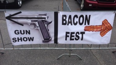A Sign in Arkansas Points One Way For Gun Show and the Other For Bacon Show