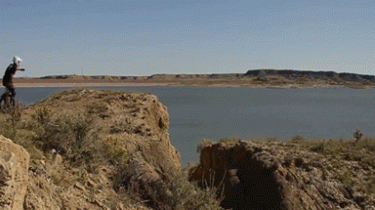 Man on a Unicycle Jumps Over a Cliff