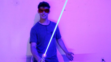 teenage boy makes home made light saber