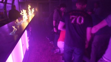 Guy Attempts to Slide Across Flaming Bar, Fails