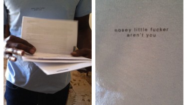 Man Wearing a T-Shirt That Says Nosey Little Fucker Aren't You