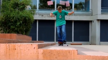 skateboarder does one footed manual while changing wheels