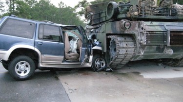 Ford Explorer Crashes Into the Side of a Tank and Loses