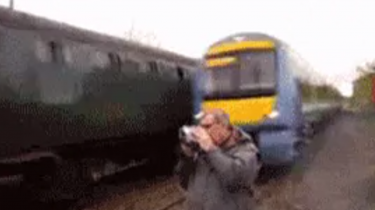guy filming train nearly hit by train