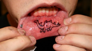 Dinosaur Inner Lip Tattoo